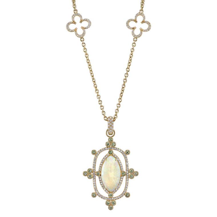 Erica Courtney Interstellar Opal pendant on a Buff Clover chain necklace. The 5.12ct Coober Pedy opal is highlighted by diamonds and demantoid garnets, and hangs from a yellow gold chain.